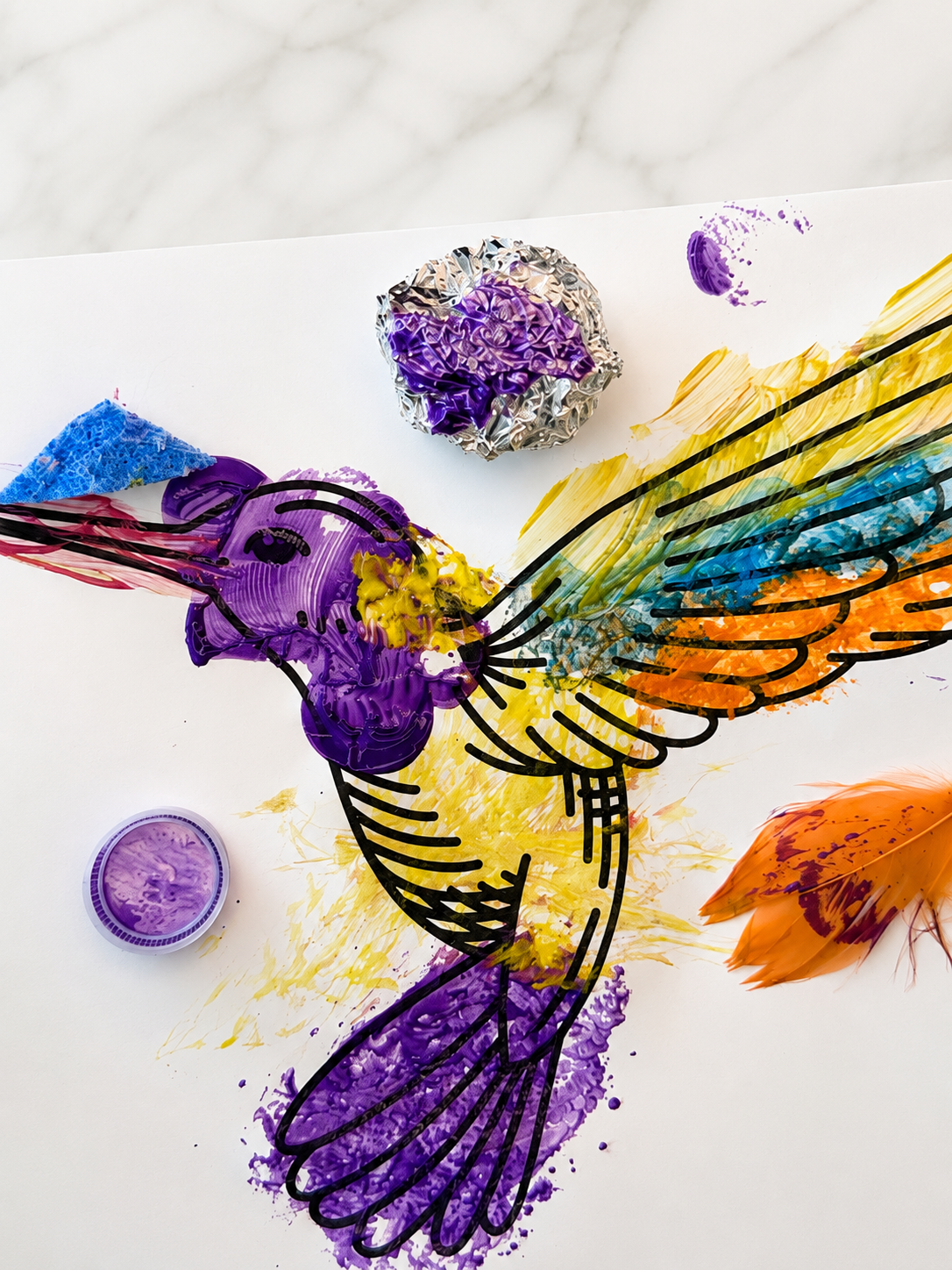 Preschool textured bird painting made with aluminum foil, a feather, a bottle cap, and a sponge